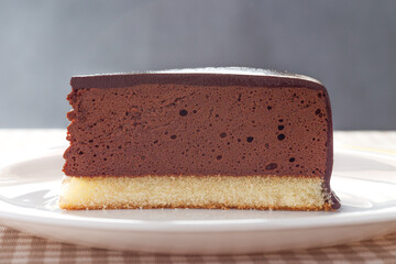 Slice of homemade mousse cake with mirror chocolate coverage