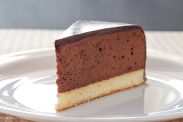 Slice of homemade mousse cake with mirror chocolate coverage