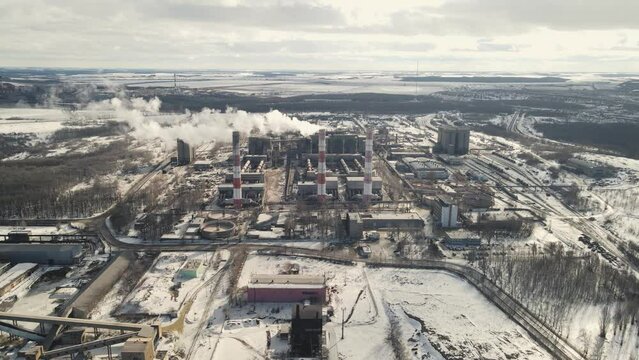 working cement plant with smoking chimneys. 4k drone footage