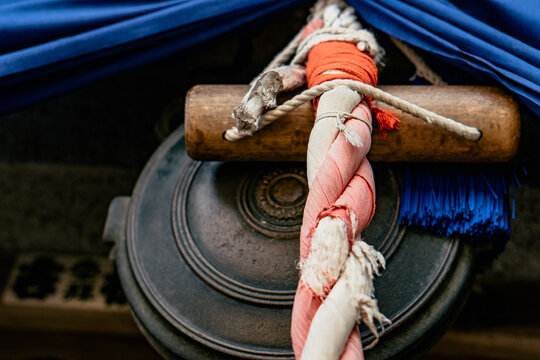 Construction with a piece of wood, weathered rope, and aged metal