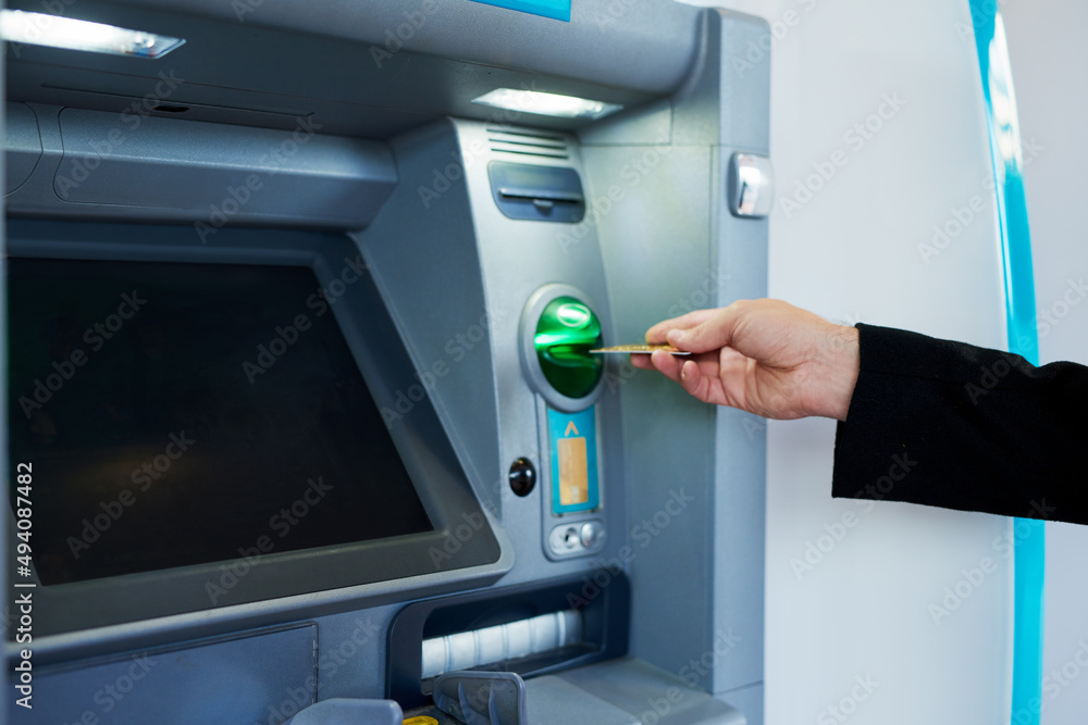 Poster transacting at the atm. cropped shot of a businessman making a transaction at an atm.