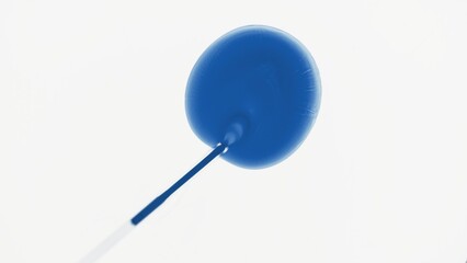 Top view macro shot of chemical dropper injects blue liquid into transparent one on white...