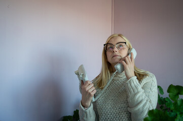Woman speaking over analogous old type phone in the office