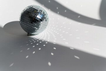 Disco ball in the sunlight on a white background