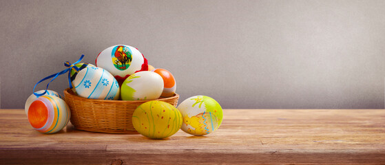 Easter background with colorful easter eggs on wooden background.