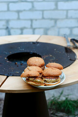 Chicken burgers cooking on an outdoor grill