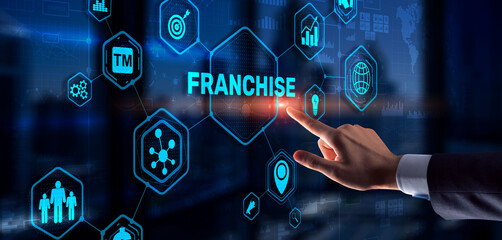 Businessman hand touching inscription Franchise marketing system
