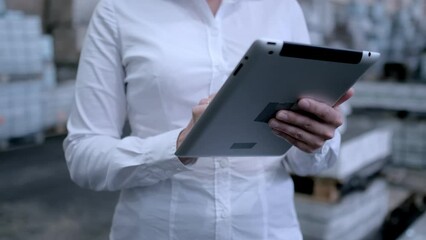 Follow footage of employees famale warehouse worker engineer in hard hat working. walking through logistics center warehouse factory construction site logistics architect businessman man builder