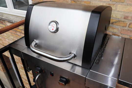 Large gas grill on the balcony. Cooking barbecue. High quality photo