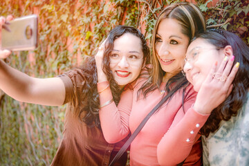 Happy smiles. Three girls taking selfie and looking happy