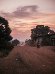 a dreamy and sandy road in liberia, west africa during sunset