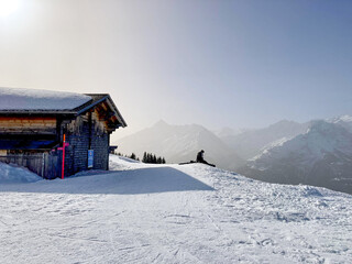 Wooden House in a sunny Winter Landscape in Switzerland
