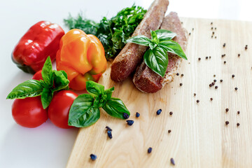 meat on a wooden board with vegetables