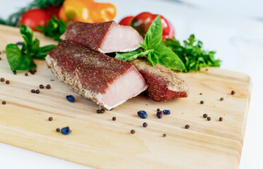 meat on a wooden board with vegetables