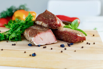 meat on a wooden board with vegetables