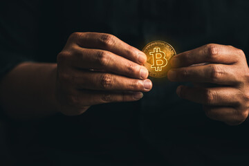 cryptocurrency golden bitcion. hand holding gold bitcoin - virtual Btc neon sign for trading web  and international network payment.
