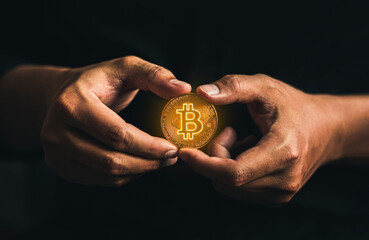cryptocurrency golden bitcion. hand holding gold bitcoin - virtual Btc neon sign for trading web ...