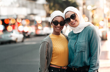 We are muslim and proud. Cropped shot of two attractive young women wearing sunglasses and...