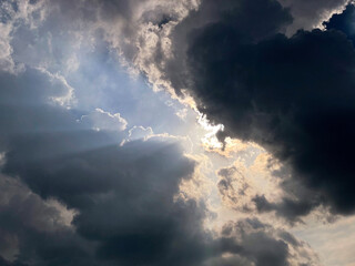 Dark clouds obscuring the sun, allowing only a few weak rays to pass through
