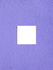 Facade of coarse fraction with grain texture painted in purple color with white paper card. Minimal...