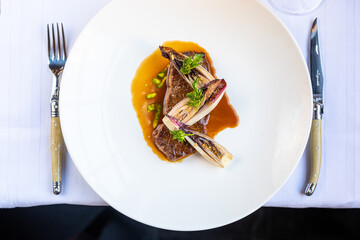 Grilled steak with colourful vegetables served in restaurant on white linnen