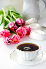 Romantic morning cup of tea. Bouquet pink tulip. Selective focus.