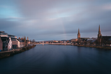 Fototapeta na wymiar Beautiful cityscape of morning city and river with rainbow. River Ness, Inverness, Scotland