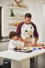 Obraz premium Baking and bonding. Shot of a father and his young son baking cookies together in the kitchen.