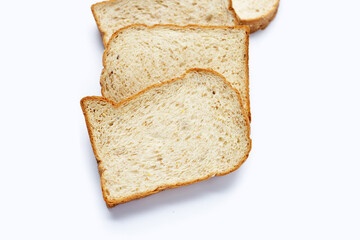 Stack of sliced wholegrain bread on white background.