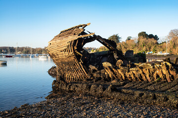 wreck of an old boat on a beach in Brittany, France