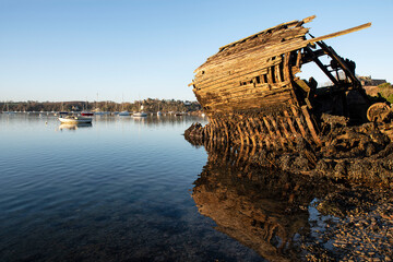 wreck of an old boat on a beach in Brittany, France