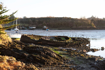 wreck of an old boat on a beach in Brittany, France