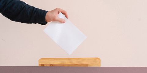 a voter hand put paper in the urn, democracy election - obrazy, fototapety, plakaty
