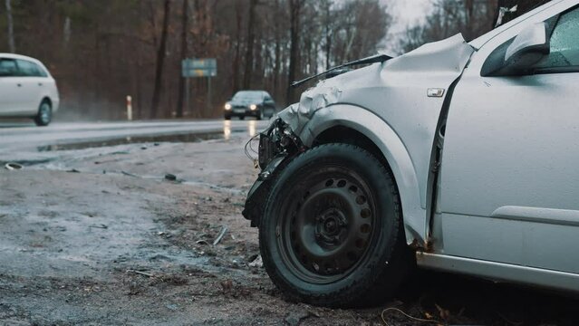Deadly car accident - car wreck left on a roadside during winter rainy day in Europe. High quality 4k footage