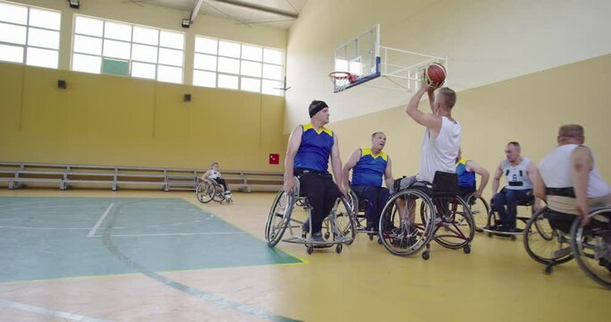 Persons with disabilities playing basketball in the modern hall
