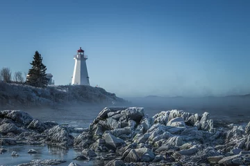 Fotobehang Green's Point Lighthouse in L'Etete Saint George New Brunswick Canada - Winter frozen landscape cold © Dana
