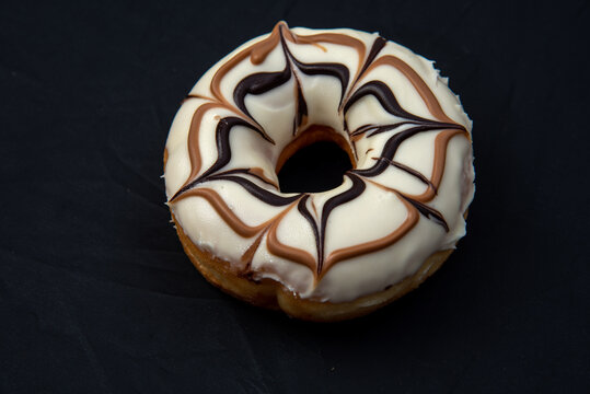 DonutDelicious donut with caramel glazed, Isolated on white and wood background. High quality photo