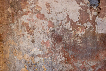 grimy and irregular textured surface of an abandoned and weathered wall - brown and gray colors