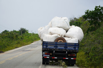 Load securing. Broken truck in which the load of heavy plastic bags was inadequately secured. The...