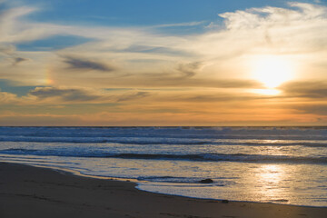 Naklejka na ściany i meble Sunset on the beach, beautiful cloudy sky on background
