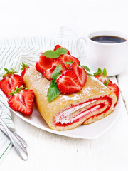 Roll with cream and strawberries in plate on light board