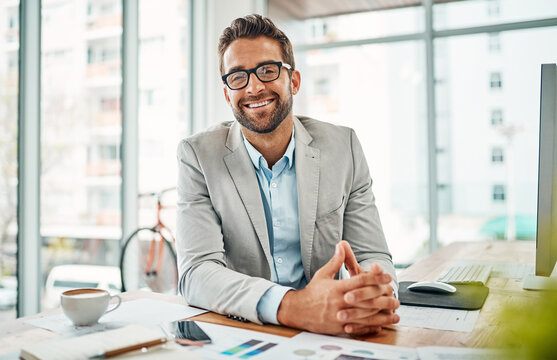 Its Been A Successful Workday. Portrait Of A Handsome Young Businessman Sitting In An Office.