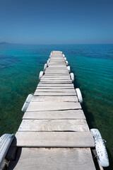 Beautiful white old wooden pier on the seashore on a beautiful sunny day. Corfu Greece