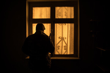 Conceptual photo of war between Russia and Ukraine. Ukraine and Russia flags on windowsill at...