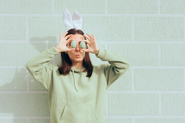 Happy Woman with Bunny Ears Holding Easter Eggs as Eyeglasses