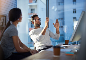 Turning his vision into reality. Shot of a young businessman explaining an idea to his coworker at...