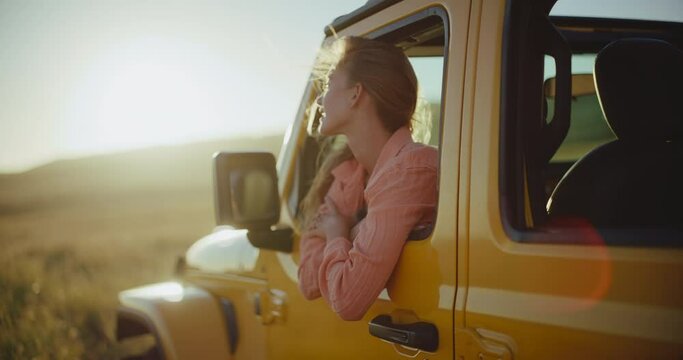 Epic sunset road trip, beautiful young blond woman looking out at the window, freedom and adventure lifestyle