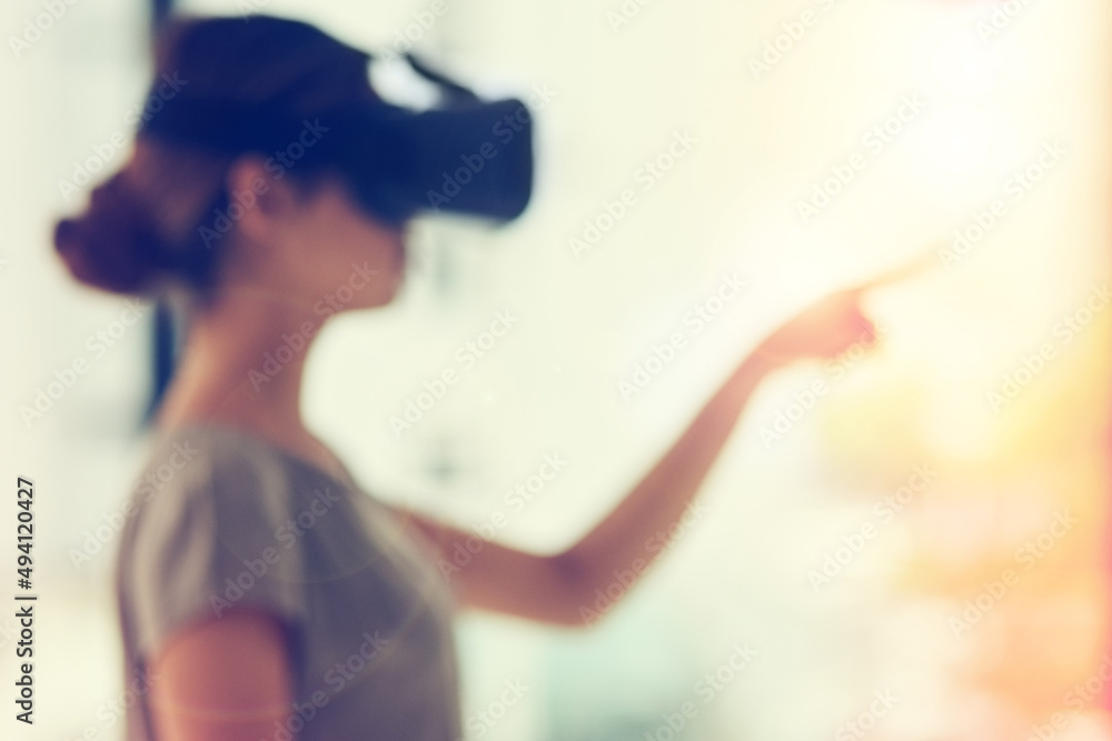 Poster connecting to a world of opportunity. defocused shot of a young businesswoman wearing a vr headset w