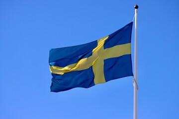 Sweden flag waving in strong wind on a sunny summer day