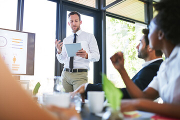 Lets review. Cropped shot of a businessman giving a presentation in the boardroom.